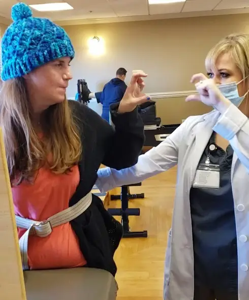 two woman making half heart shape with hands